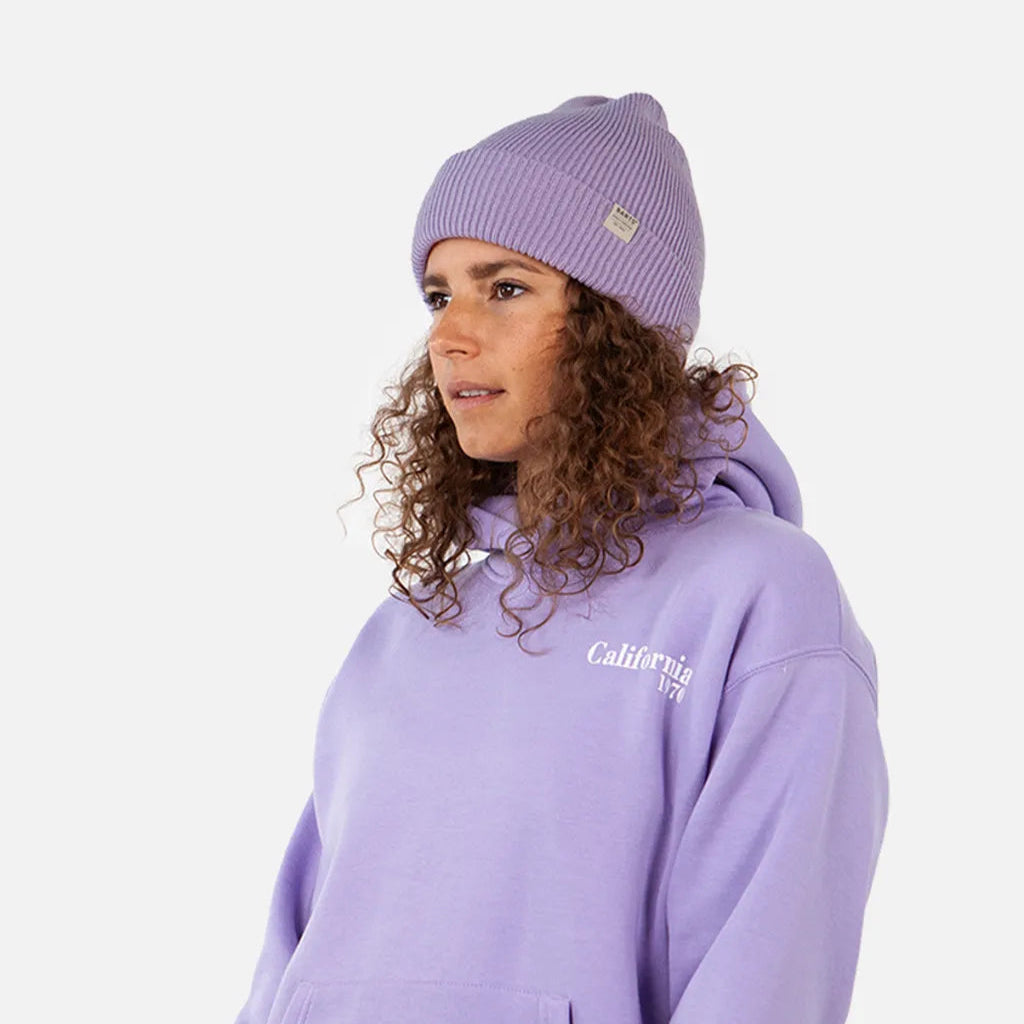 Person wearing a purple hoodie and beanie with 'Calvin Klein' branding on a white background